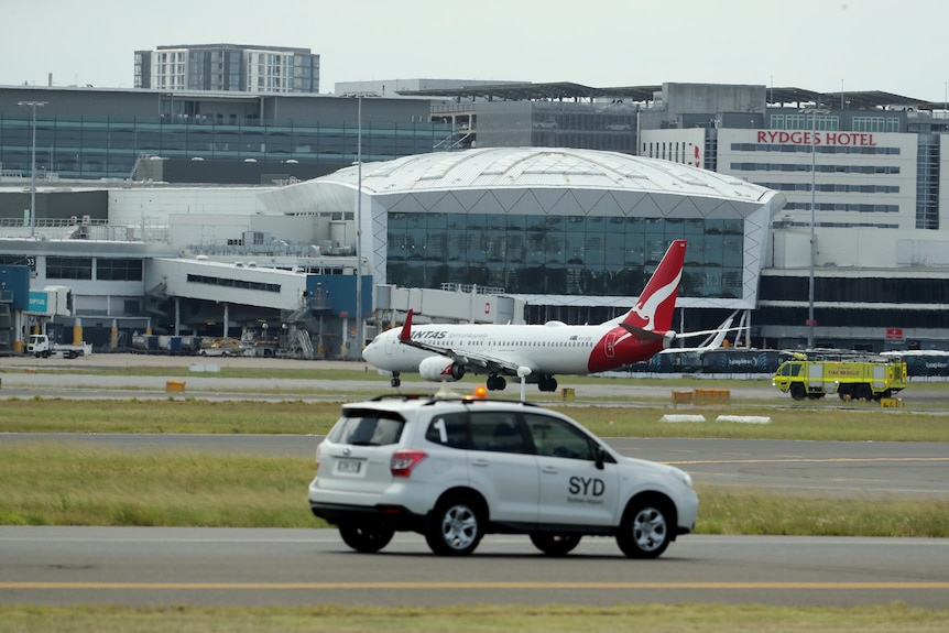 A car in front of a plane