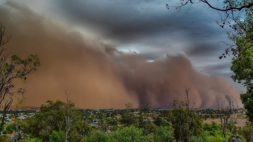 A large dust storm over a country area.