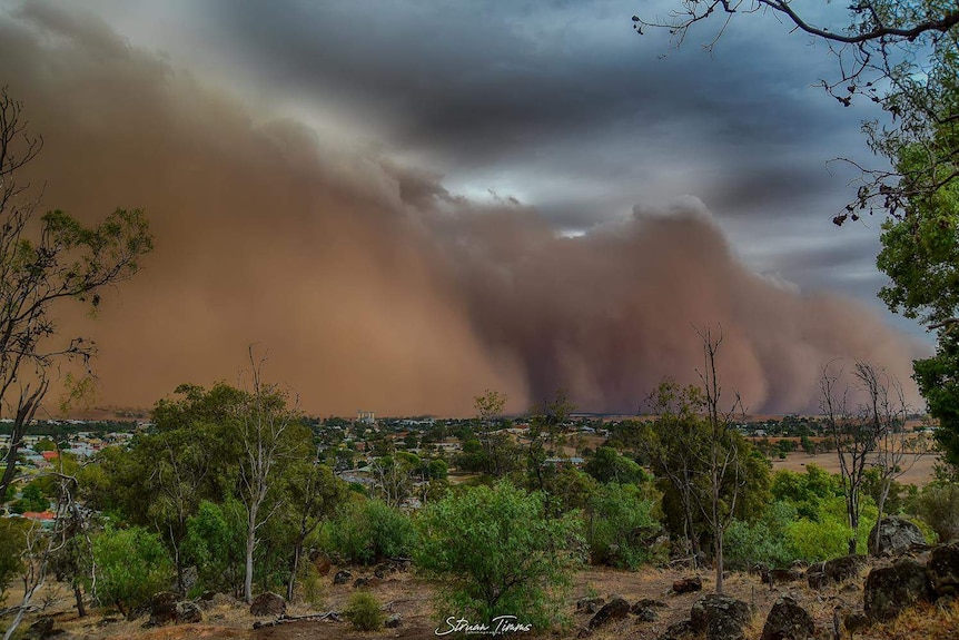 A large dust storm over a country area.