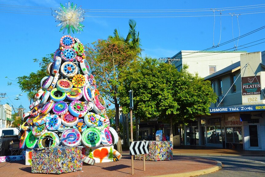 A colourful Christmas tree made of car tyres in the middle of a round about.