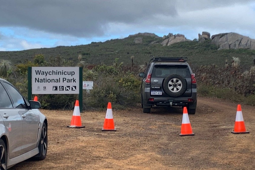 Police close a beach access road as they search for a person missing off rugged coast near Albany.