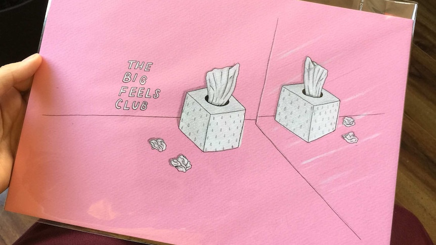 A photo of a pink envelope with artwork for the Big Feels Club.