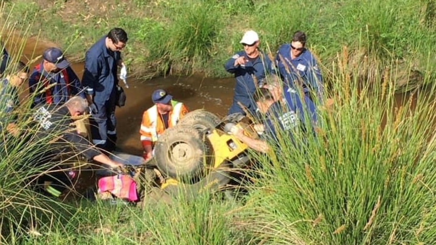 Emergency service crews working to free a man whose legs were pinned underneath a lawnmower.
