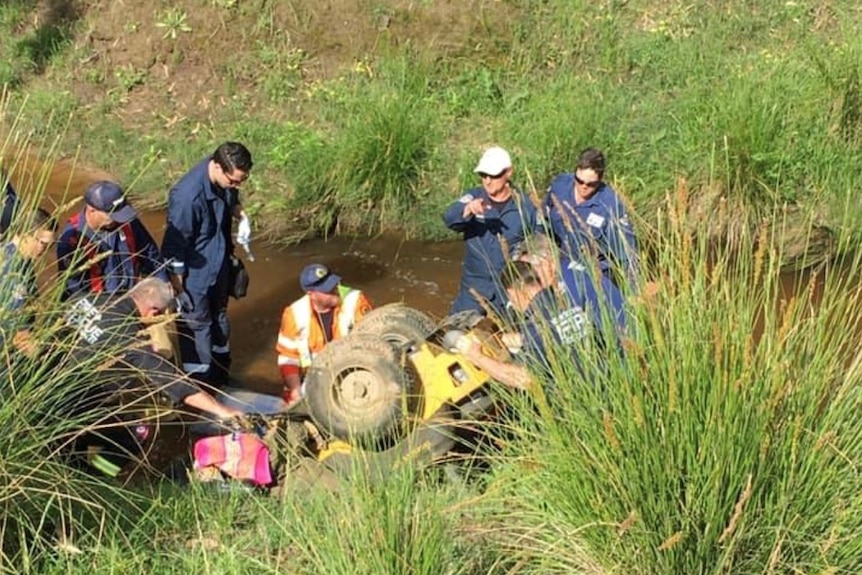 Emergency service crews working to free 77-year-old Russell Adams whose legs were pinned underneath a lawnmower.