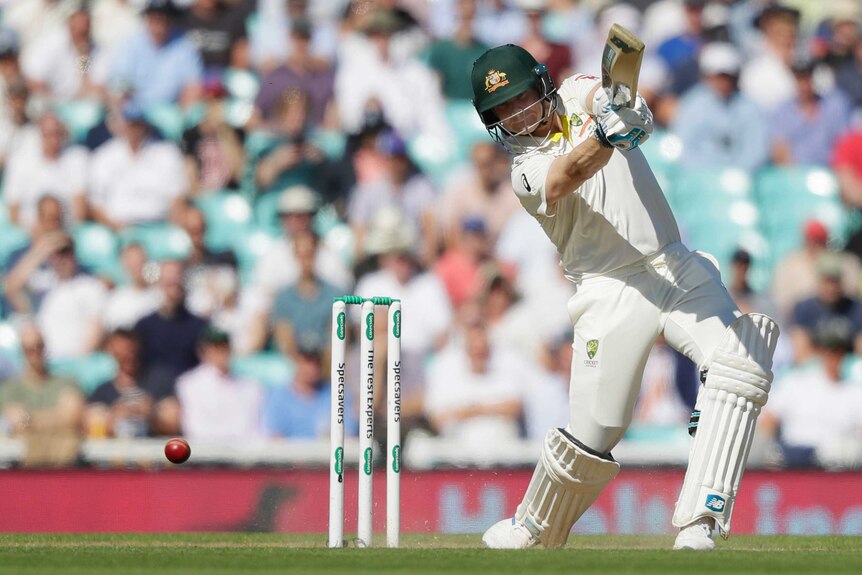 A cricket ball runs away from Australia batsman Steve Smith as he completes a drive.
