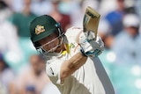 A cricket ball runs away from Australia batsman Steve Smith as he completes a drive.