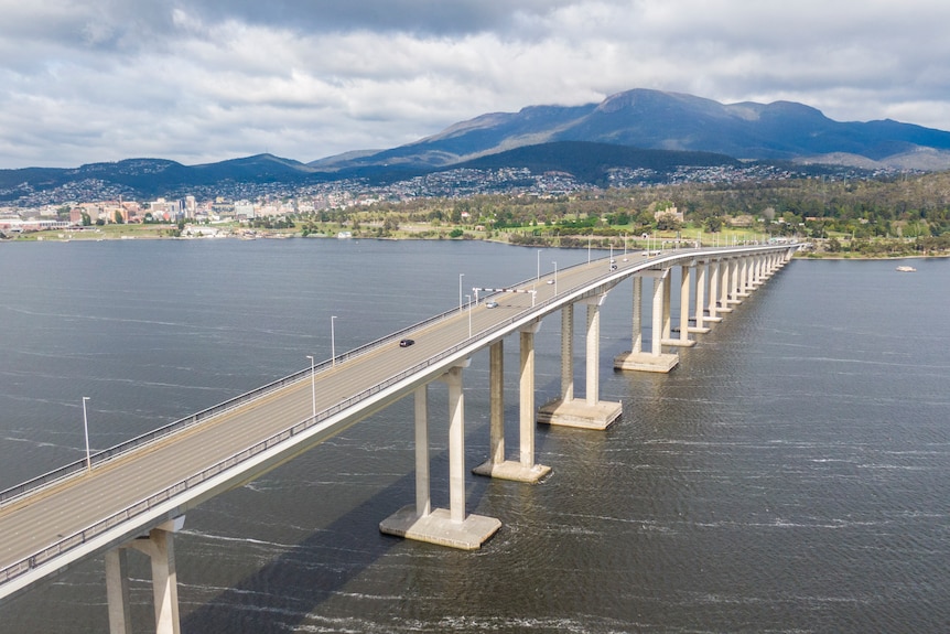 A deserted bridge across the River Derwent. Mt Wellington sits in the background. 