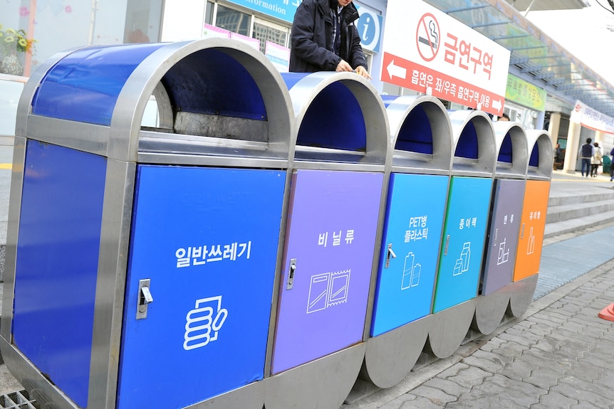A line of colourful bins with Korean text.