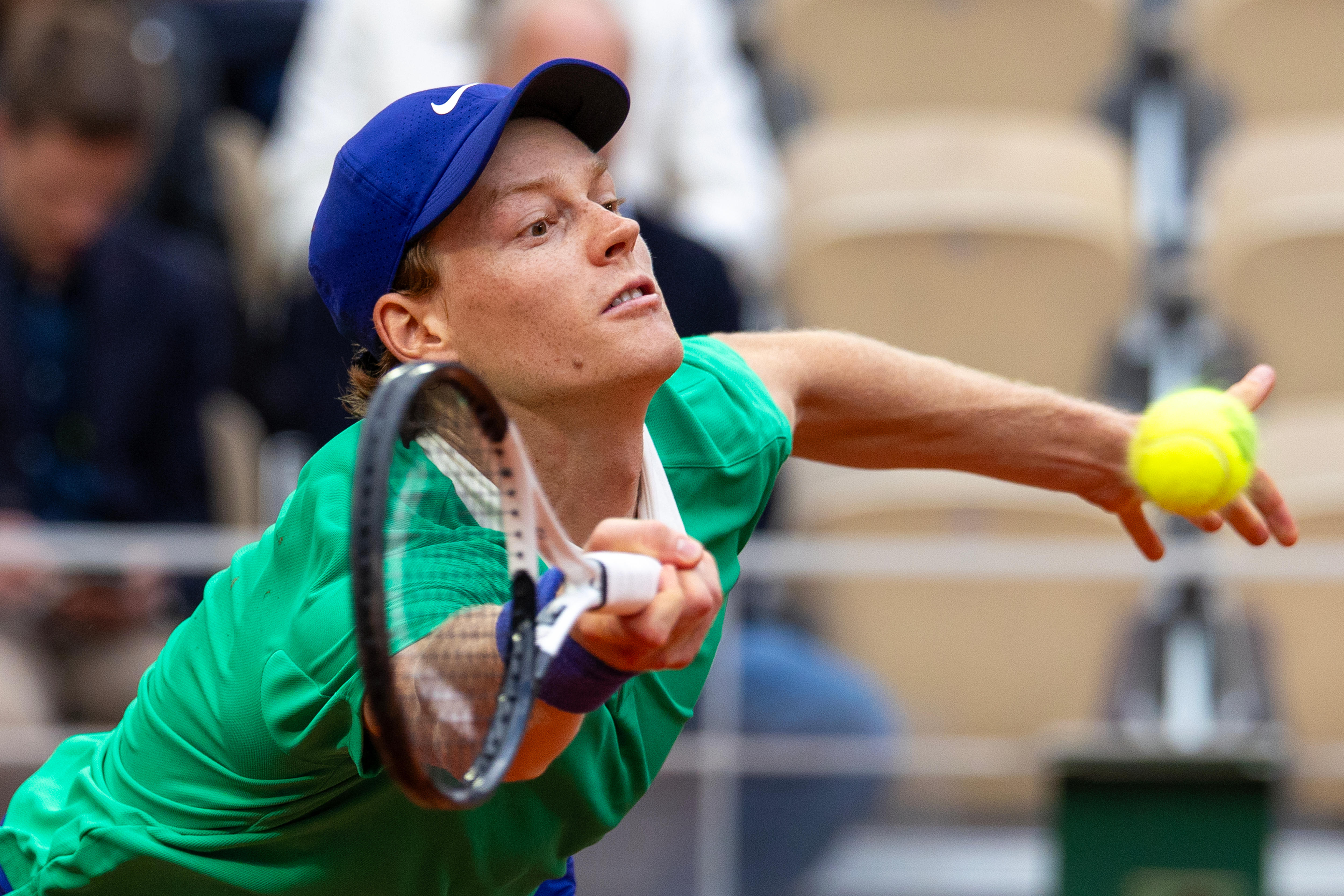 Jannik Sinner stretches for a forehand at the French Open.