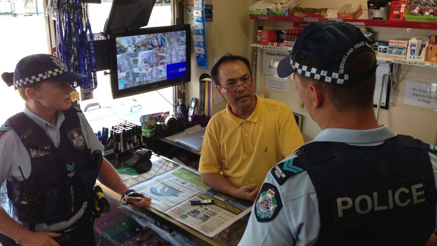 Logan business owner Victor Lee speaks with police about extra patrols in Woodridge, south of Brisbane, in August 2013.