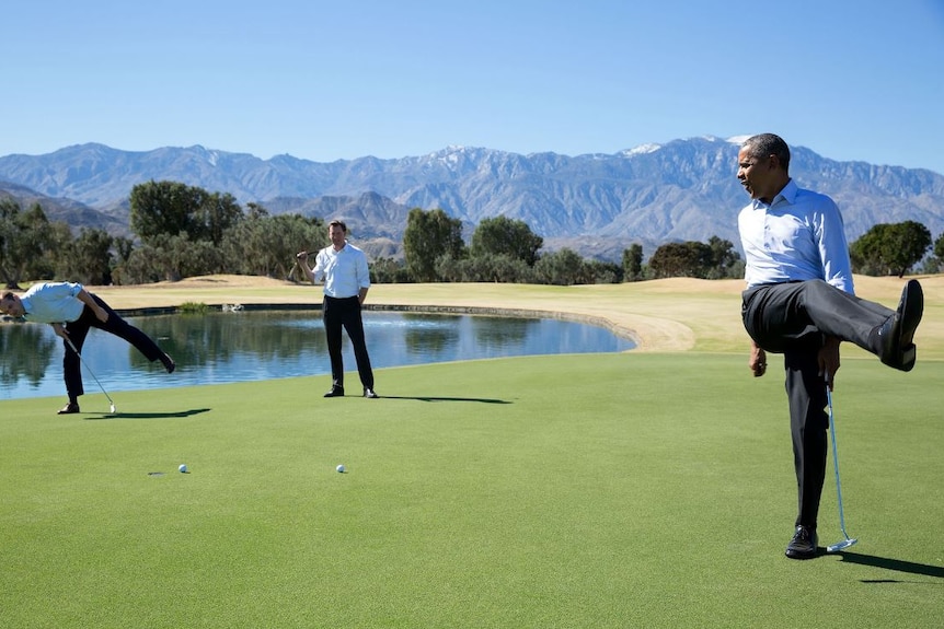 Obama reacts as his putt falls just short during an impromptu hole of golf