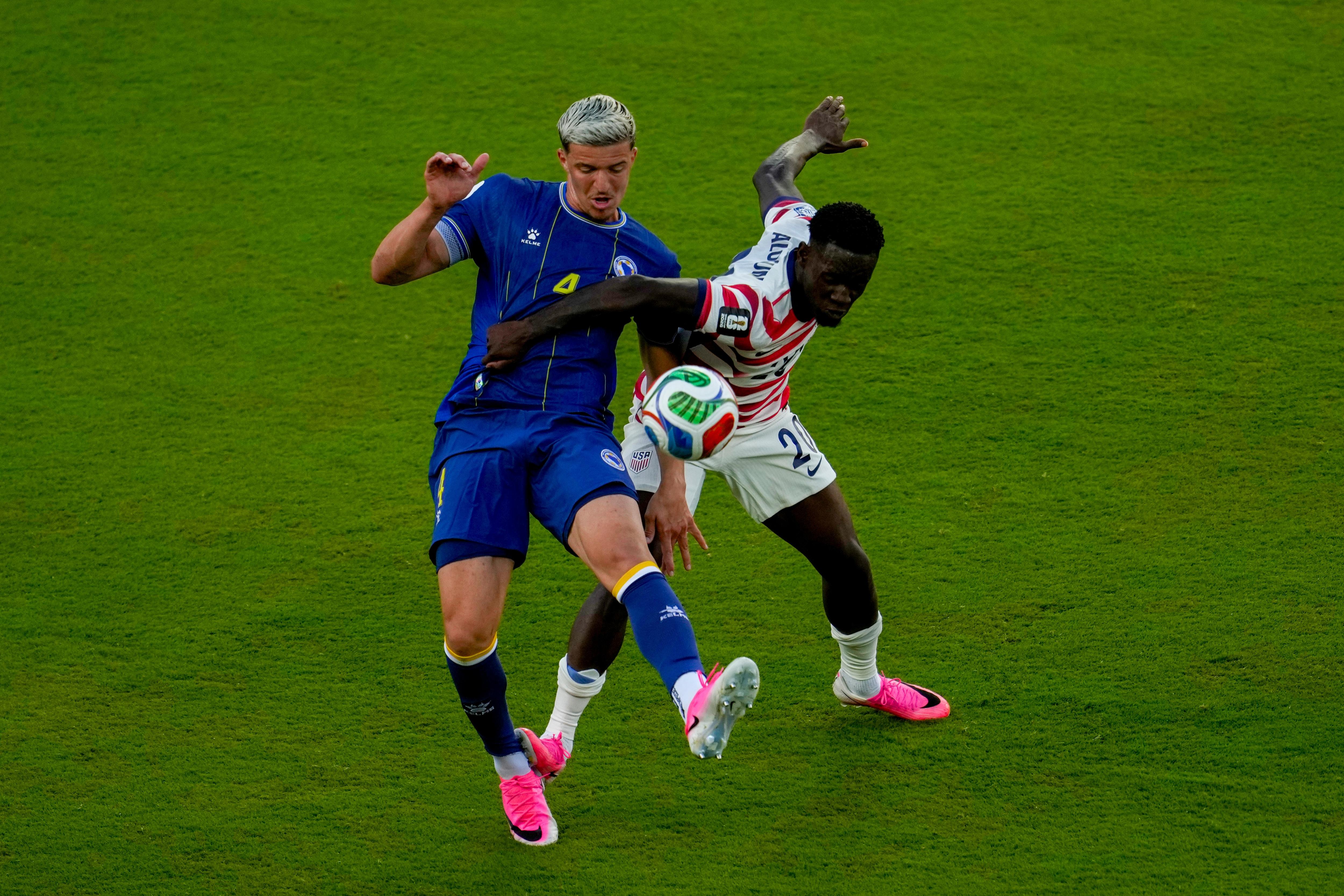Folarin Balogun's foot slightly pushing on Tarik Muharemović's ankle.