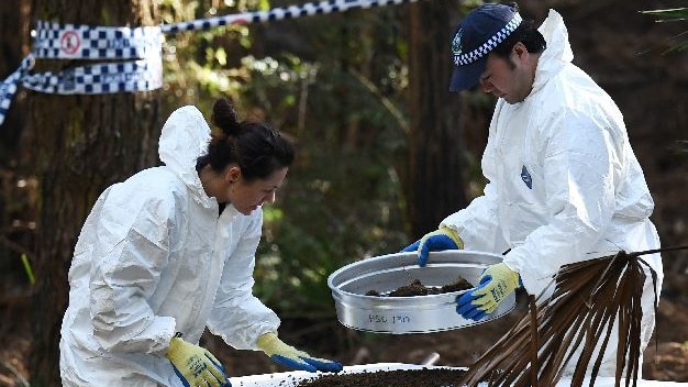 Police with soil samples in the national park.