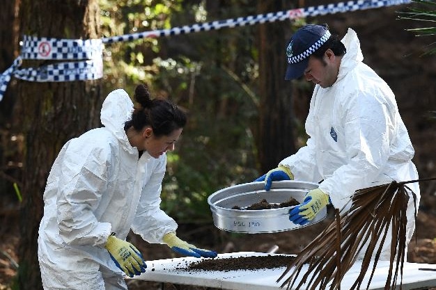 Police with soil samples in the national park.