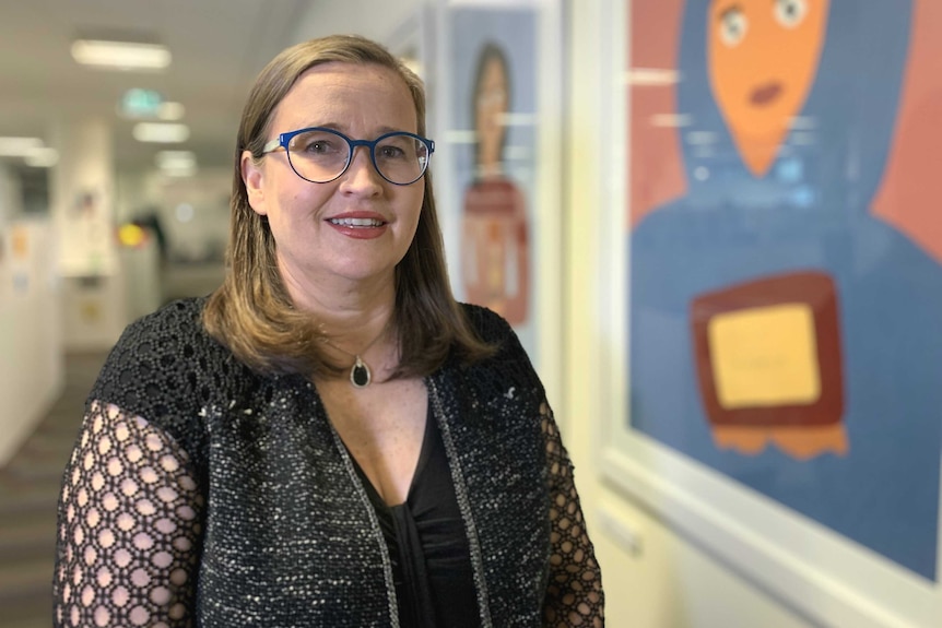 Sexual Discrimination Commissioner Kate Jenkins in an office environment looking at the camera.