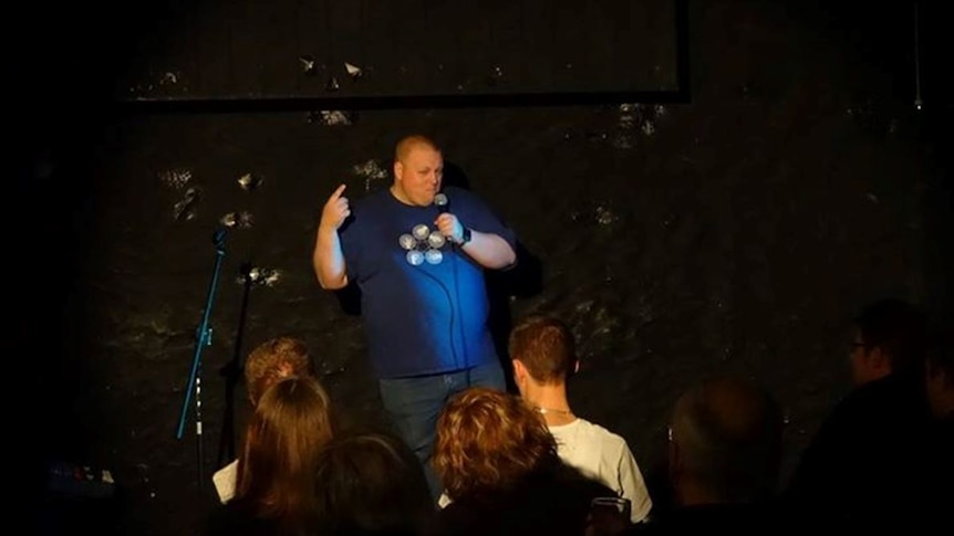 Ben Klingberg on stage during a comedy gig in Hobart.