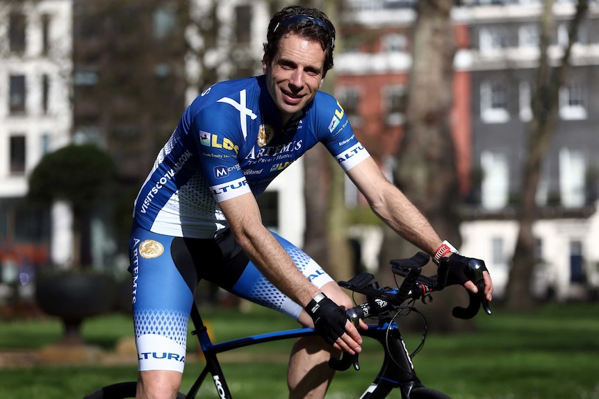 Cyclist Mark Beaumont poses with his bicycle.