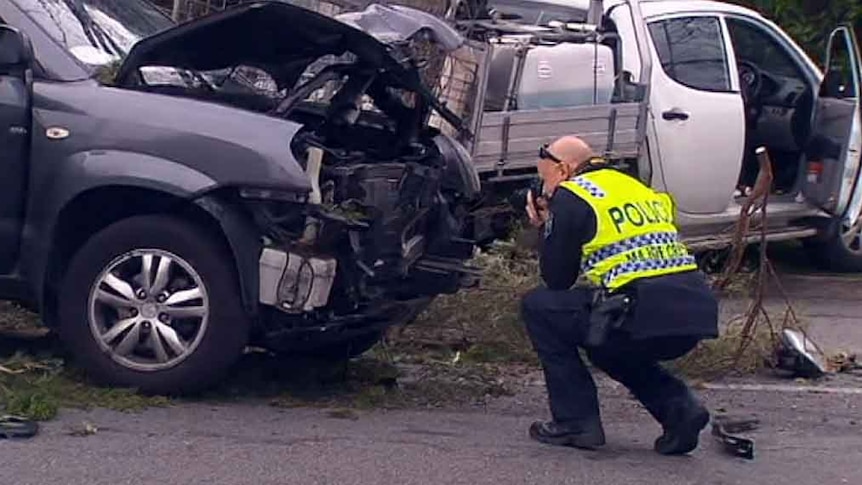 Policeman takes photos at the accident scene.