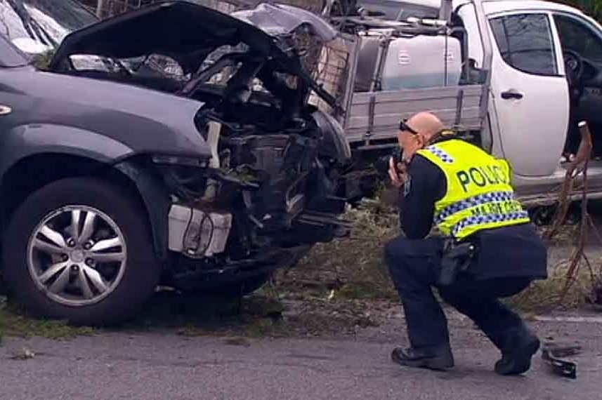 Policeman takes photos at the accident scene.