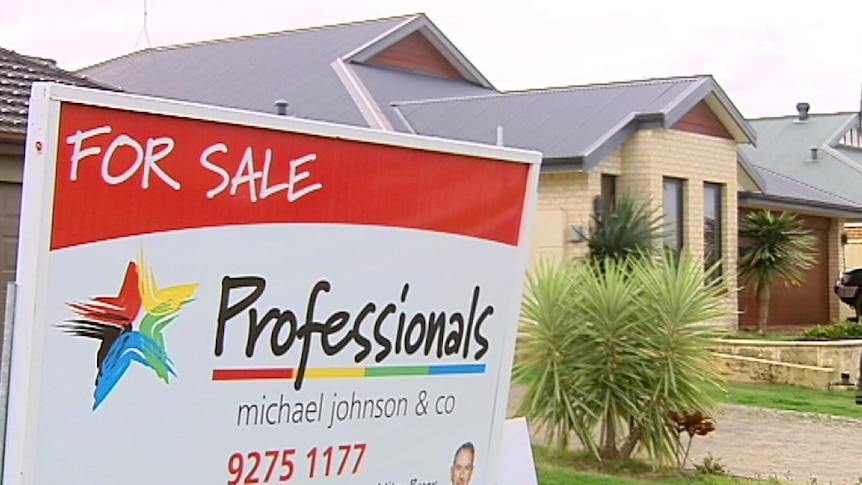 Housing market sale sign outside a house