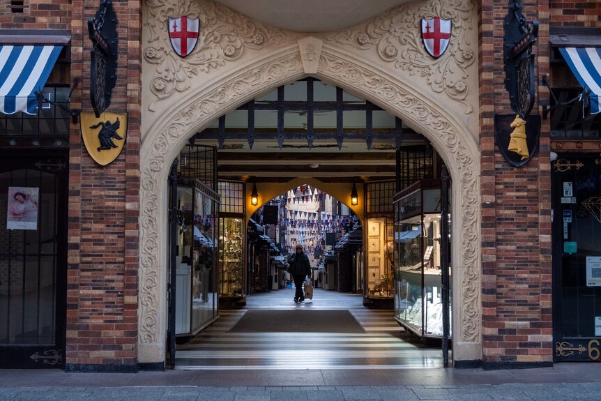 A lone shopper pictured under the arch of London Court in Perth.