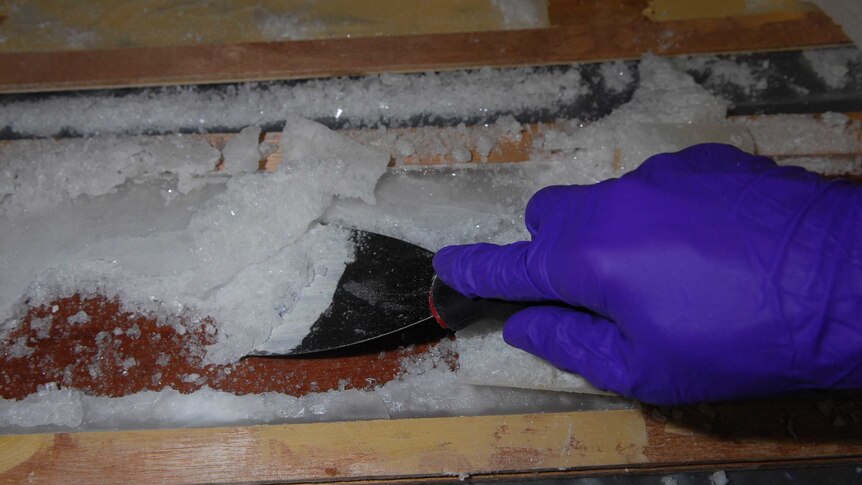 Police remove ice from cavities in wooden floorboards found in Melbourne.