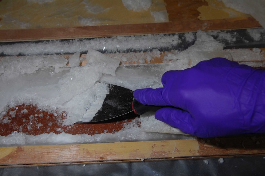 Police remove ice from cavities in wooden floorboards found in Melbourne.
