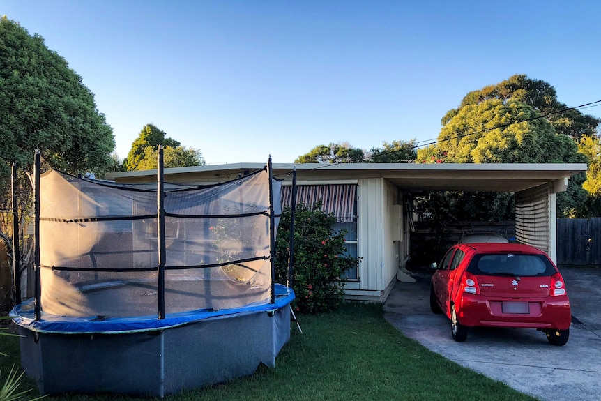 A home in Tootgarook, with a trampoline in the front yard and a red car in the driveway.