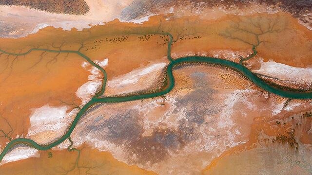 A drone photo of a river running through the drying salt plains near Exmouth, WA.