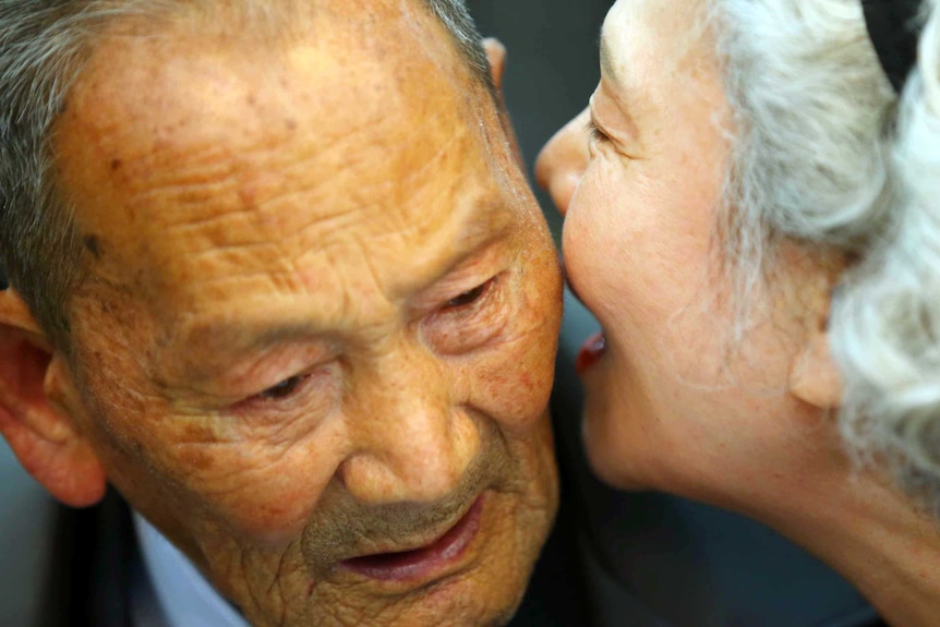 North Korean father Ri Heung-jong (L) is reunited with his daughter Lee Jeong-sook