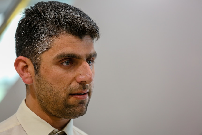 A head and shoulders shot of taxi driver Khan Nasser speaking to the ABC.