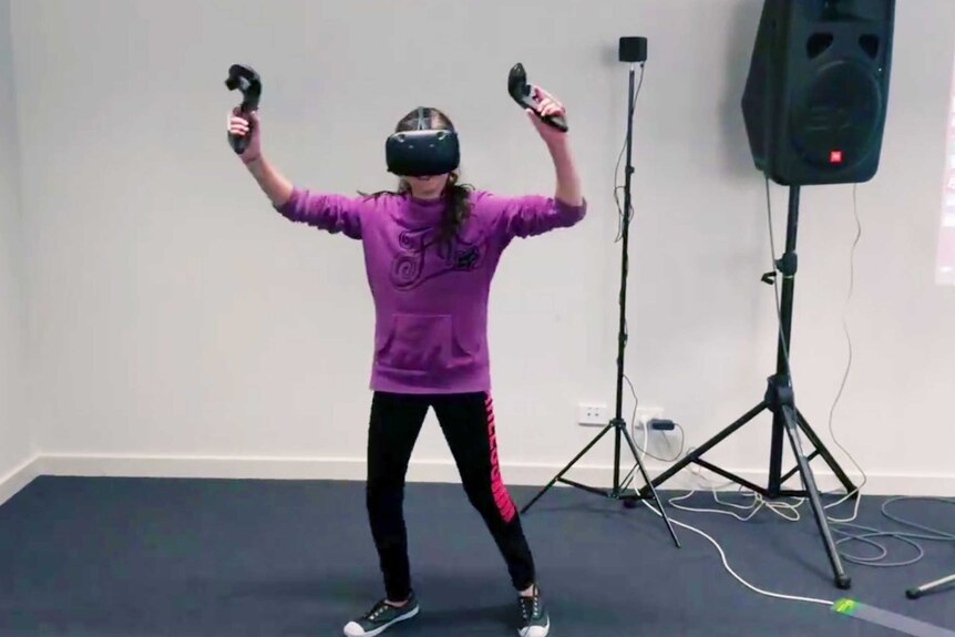 Young person uses virtual reality equipment