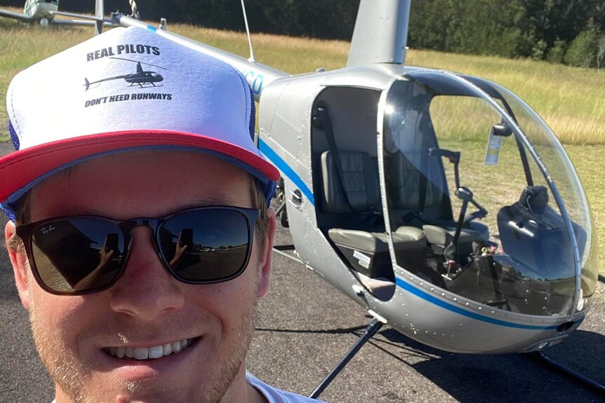 Man in front of helicopter 