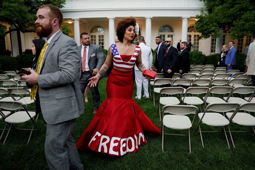 Joy Angela Villa wearing an American flag dress with the word FREEDOM on it.