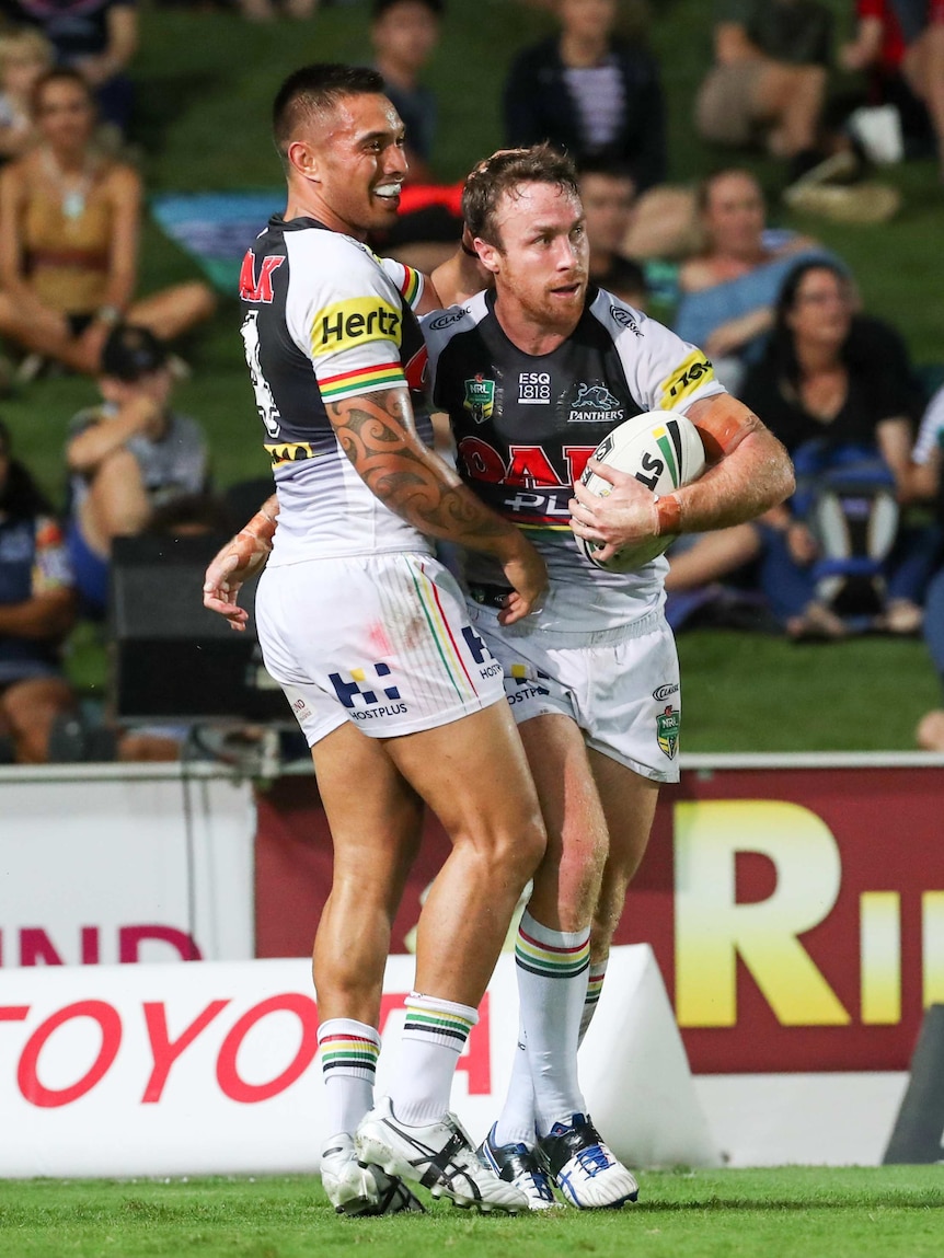 James Maloney is congratulated by Dean Whare after scoring a try for Penrith against North Queensland.
