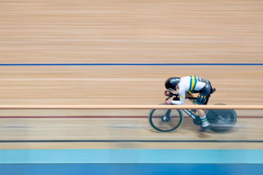 A track cyclist speeding on a bike track