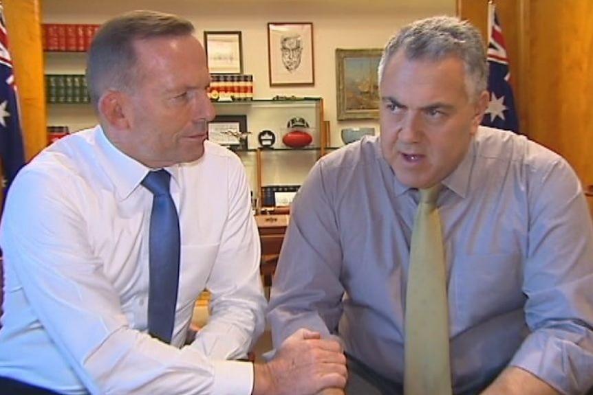 Tony Abbott lends Joe Hockey a hand as they prepare the 2015 budget.