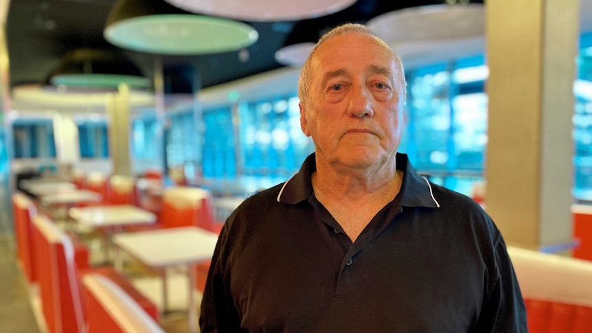 Glen Day wears a black shirt inside a restaurant.