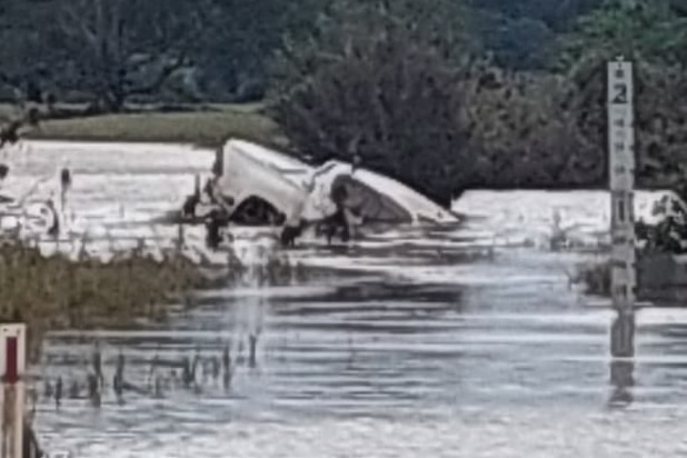 A ute submerged in floodwater.