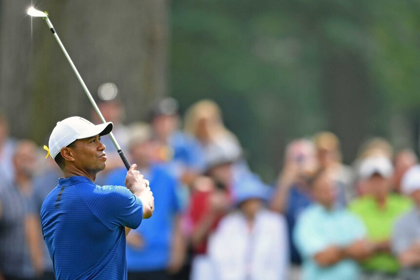 Tiger Woods follows through on his approach shot at the World Golf Championships Invitational.