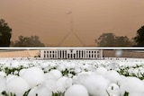Photographs of smoke haze and hail at Parliament House show the wild weather Canberra has experienced this summer.