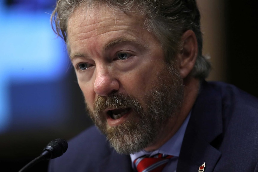 US senator Rand Paul speaking into a microphone.