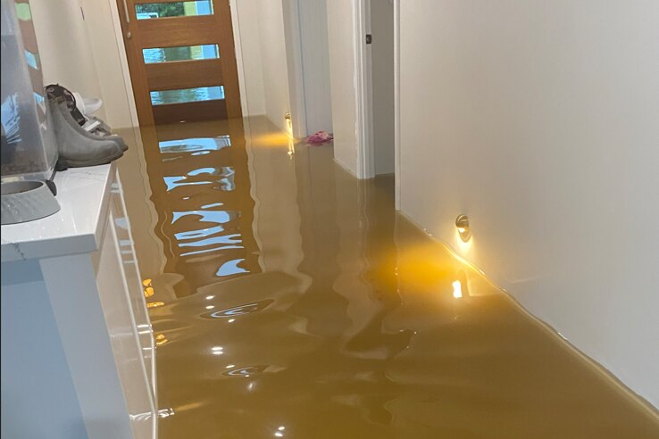 Yellow water inside a new house, deep enough that the floor can no longer be seen.