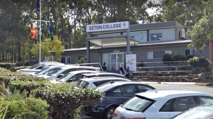 Seton College building sits in the background, with the school's car park in the foreground.
