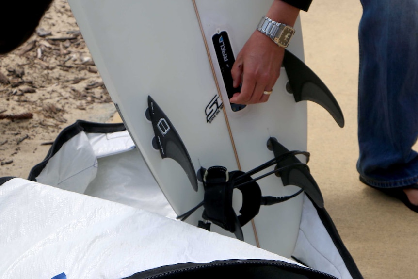 Fitting a shark repellent device to a surfboard