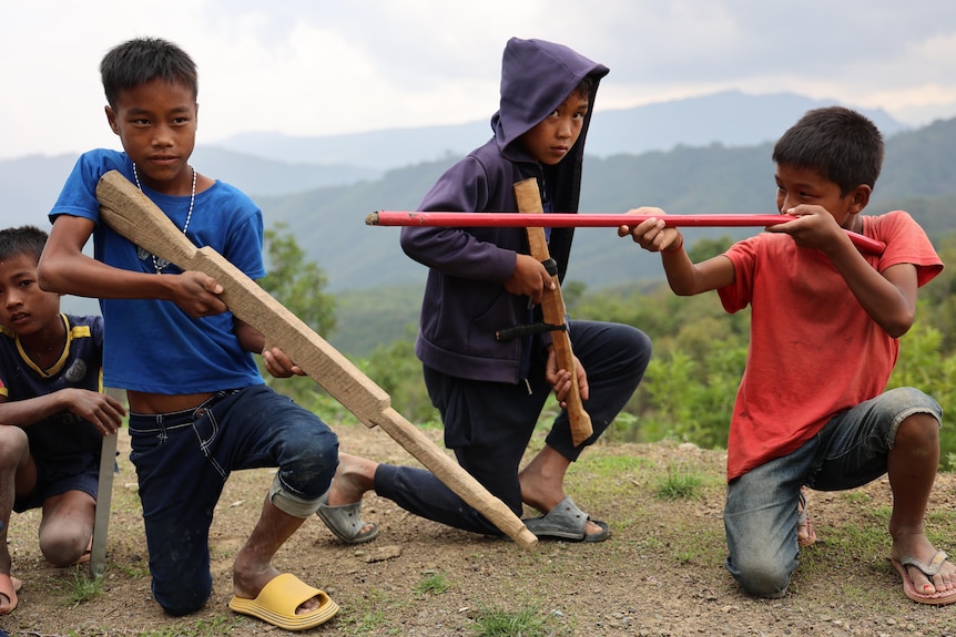 Kids with wooden guns.