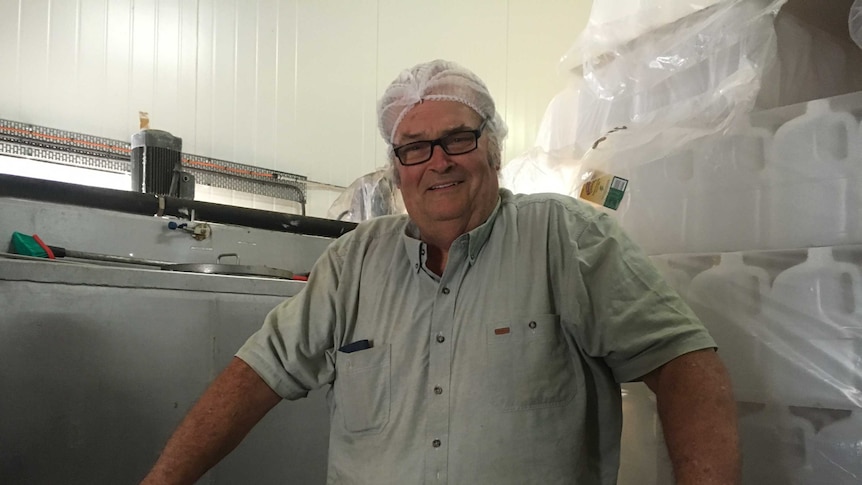 Dick Schroder stands behind a milk vat in his processing plant at Dagun.