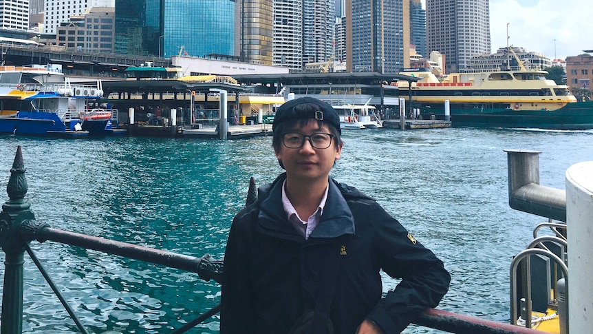 A man standing at the Sydney Harbour.