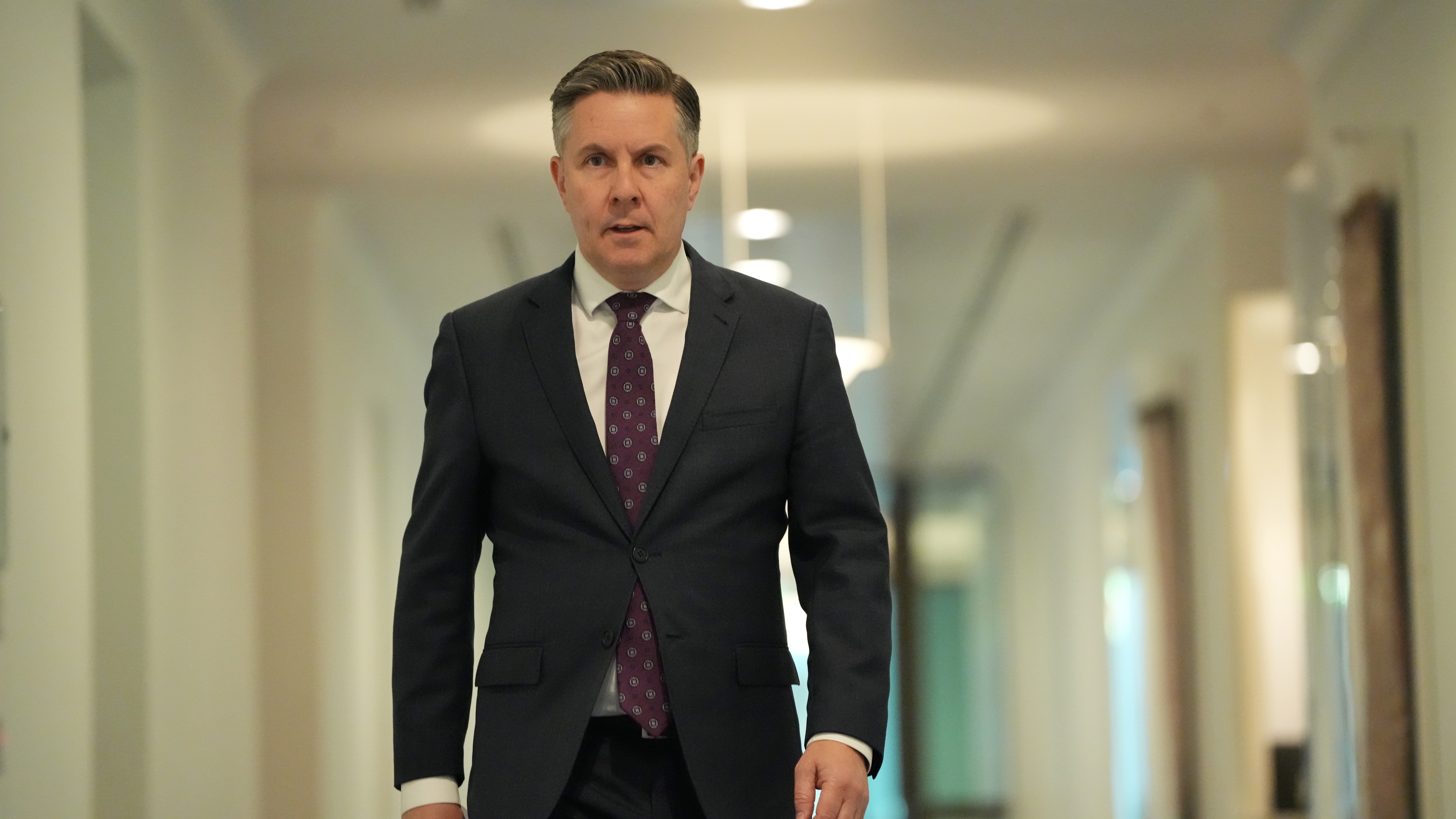 Mark Butler walks down a corridor at parliament house