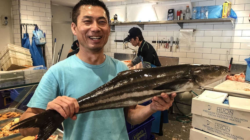 Fishmonger, Ken, holding a Cobia